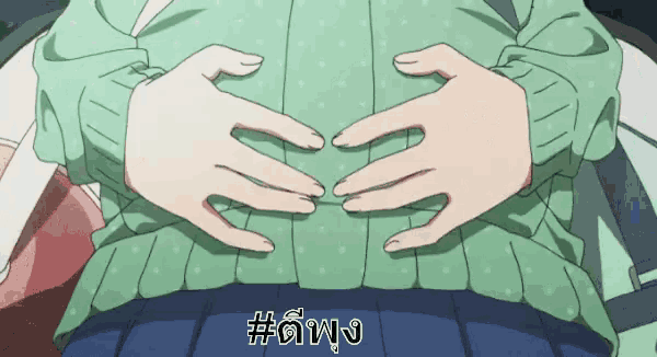 a woman in a green sweater has her hands on her stomach and the word # is on the bottom