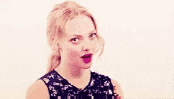 a woman is making a funny face with her mouth open .