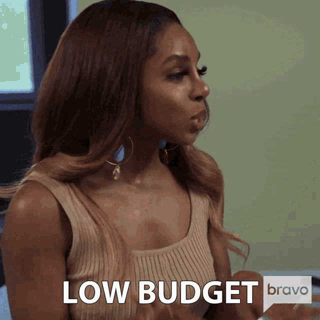 a woman in a tan tank top says low budget on bravo