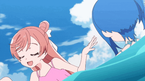a girl in a pink tank top stands next to another girl in a blue bikini
