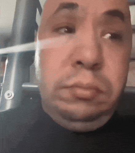 a close up of a man 's face with a reflection of a target
