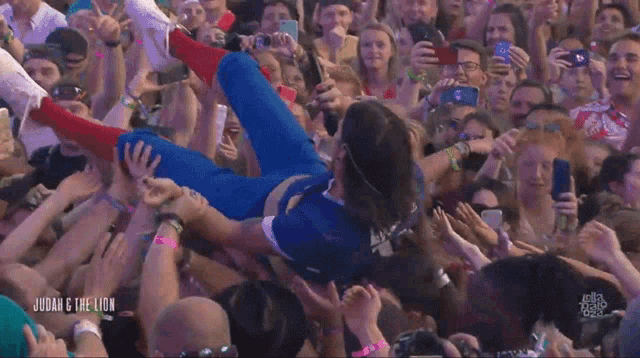 a crowd of people with judah & the lion written on the bottom right