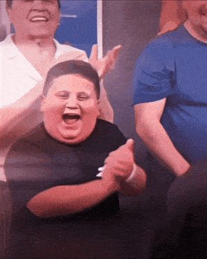 a group of people are clapping and one of them has a black shirt on that says nike