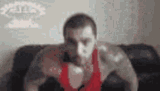 a man is doing push ups on a couch .