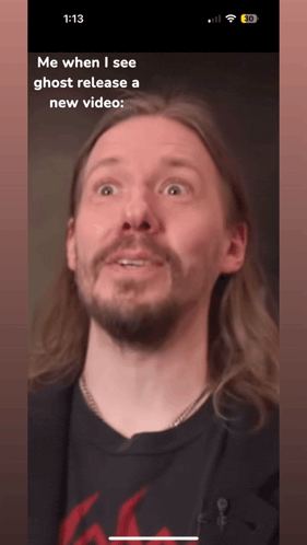 a phone screen shows a man with long hair and a beard and the words me when i see ghost release