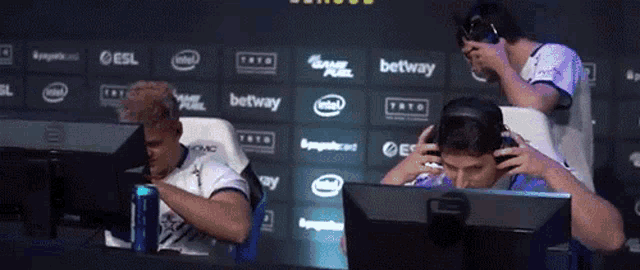 a group of people are sitting in front of a wall that says ' betway '