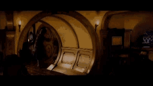 a person is walking through a doorway in a room with a couch .