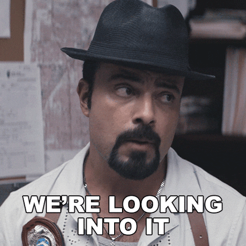a man with a beard wearing a hat and a badge says we 're looking into it