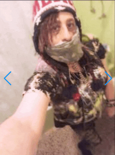 a blurry picture of a person taking a selfie with the arrow pointing to the right