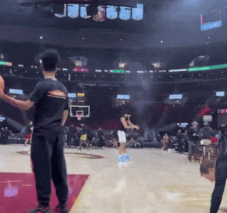 a basketball game is being played in a stadium that has a sign that says ' toyota ' on it