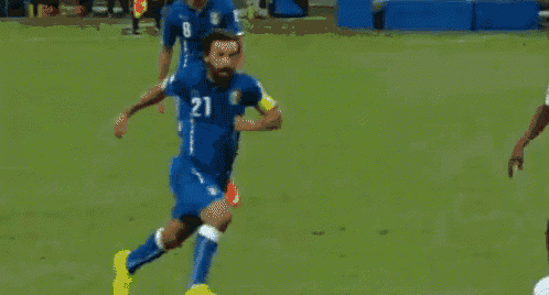 a soccer player in a blue jersey with the number 8 on it is running towards another player in a white jersey with the number 9 on it