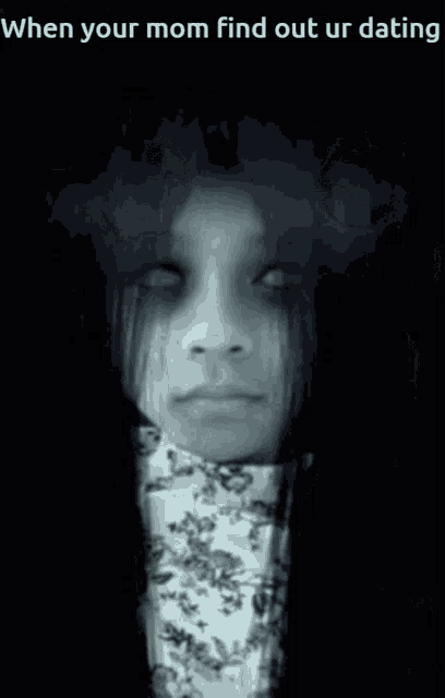 a black and white photo of a scary face with a bow tie .
