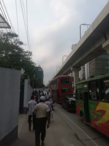 people walking down a street with a red double decker bus that says executive