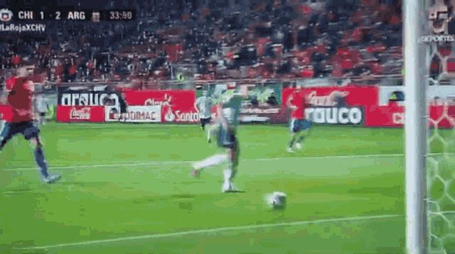 a soccer game is being played on a field with coca cola and santander ads