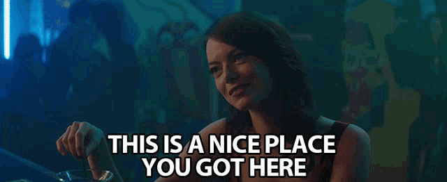 a woman sitting at a table with the words " this is a nice place you got here "