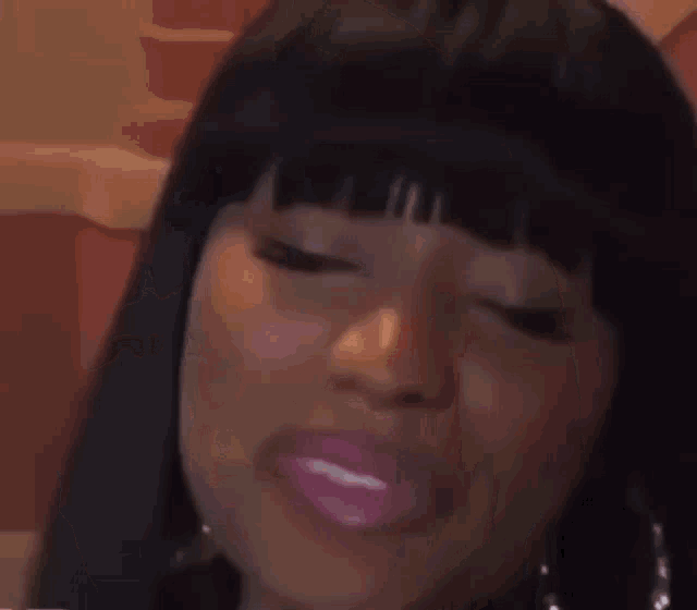 a close up of a woman making a funny face with her eyes wide open .