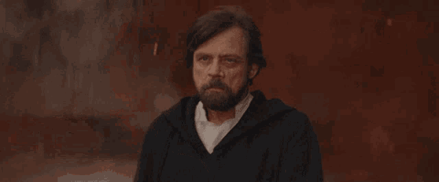 a man with a beard is making a gesture with his hands
