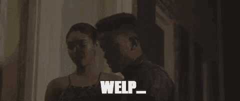a man and a woman are standing next to each other in a dark room and the man is saying welp .