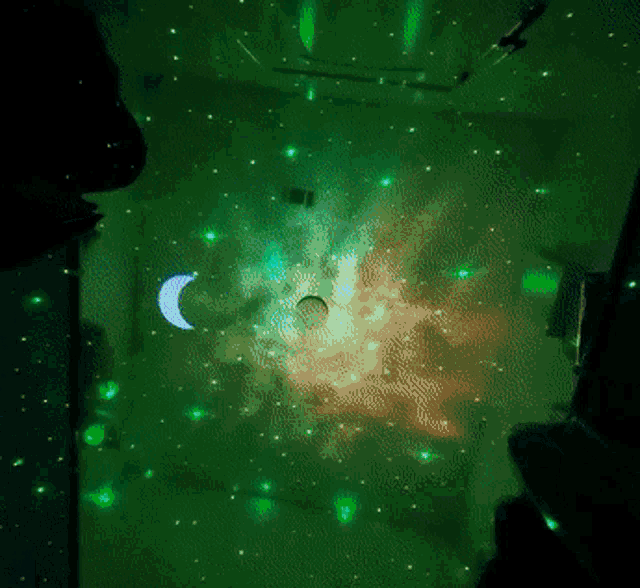 a green background with stars and a crescent moon in the middle