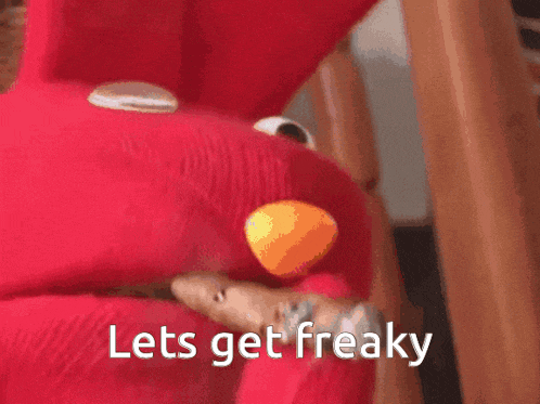 elmo is holding a cigar with the words lets get freaky below it