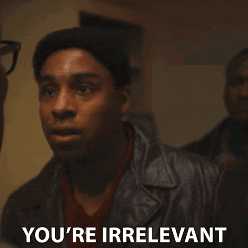 a man in a leather jacket is saying " you 're irrelevant " .