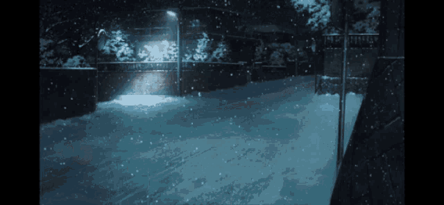 a snowy street at night with a light on