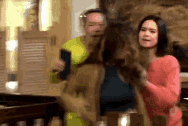 a blurry picture of a man and a woman standing next to each other