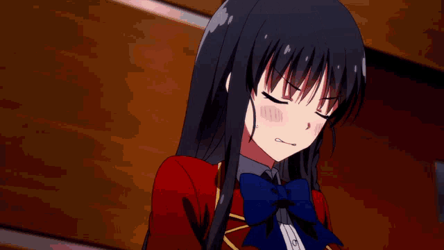 a girl with long black hair wearing a red jacket and a blue bow tie