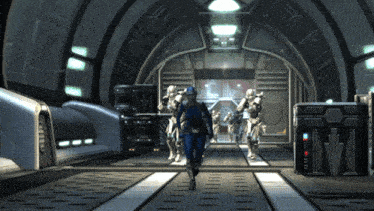 a woman in a blue suit is walking in a hallway with a group of soldiers