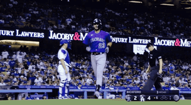 a baseball player wearing a purple uniform with the number 23 on the back