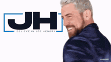 a man stands in front of a jh logo