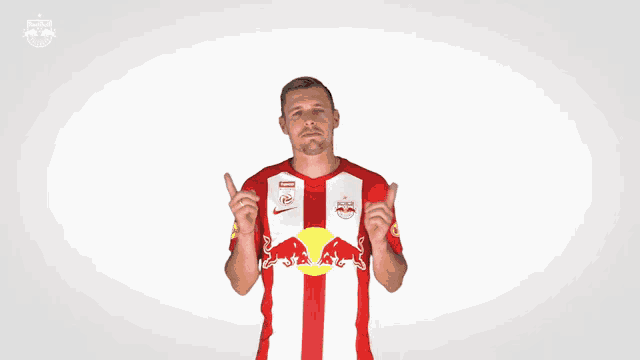 a man wearing a red and white jersey with a red bull on the front