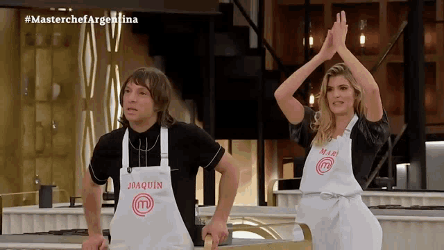 a man and a woman are wearing aprons that say master chef argentina