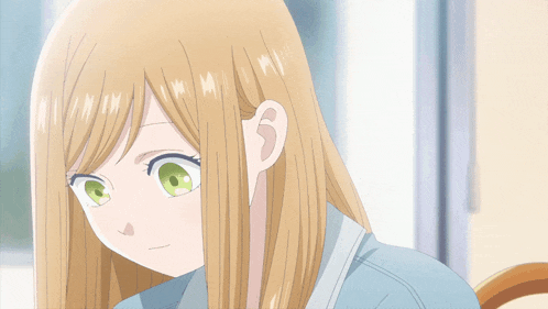 a blonde anime girl with long hair is smiling
