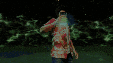 a man in a hawaiian shirt is surrounded by green flames