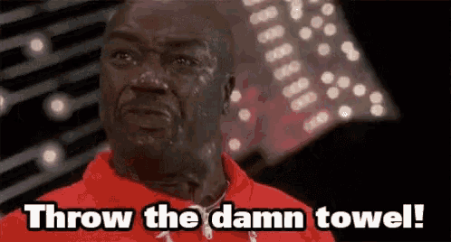 a man in a red shirt is sweating and says throw the damn towel .