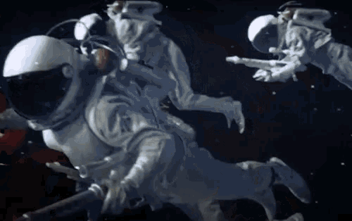 a group of astronauts are flying in space