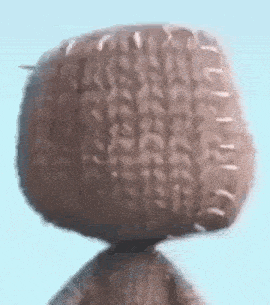 a close up of a stuffed animal 's head with stitching on it .