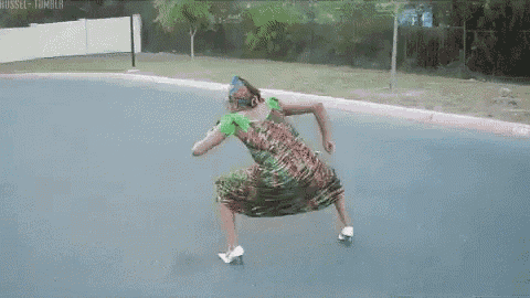 a woman in a dress and heels is dancing on the street