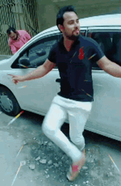 a man is dancing in front of a white van