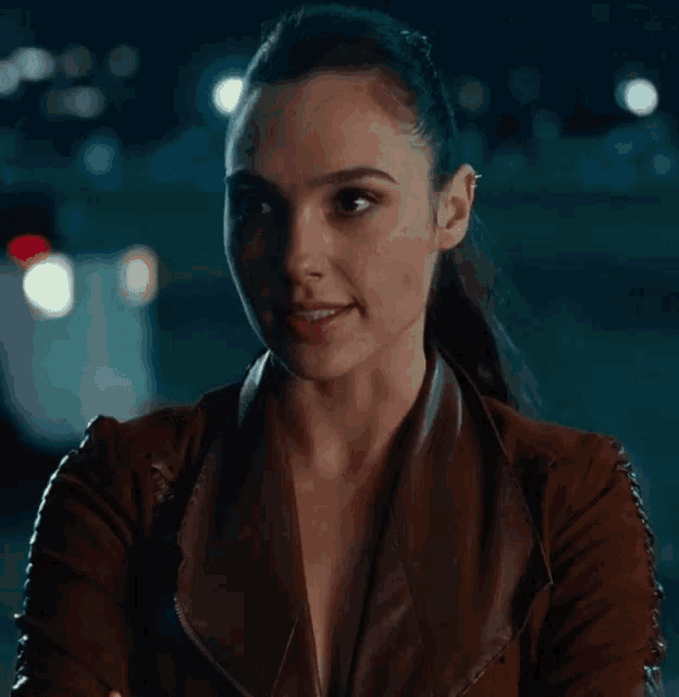 a close up of a woman wearing a brown jacket