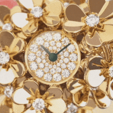 a close up of a clock with flowers around it and a green face