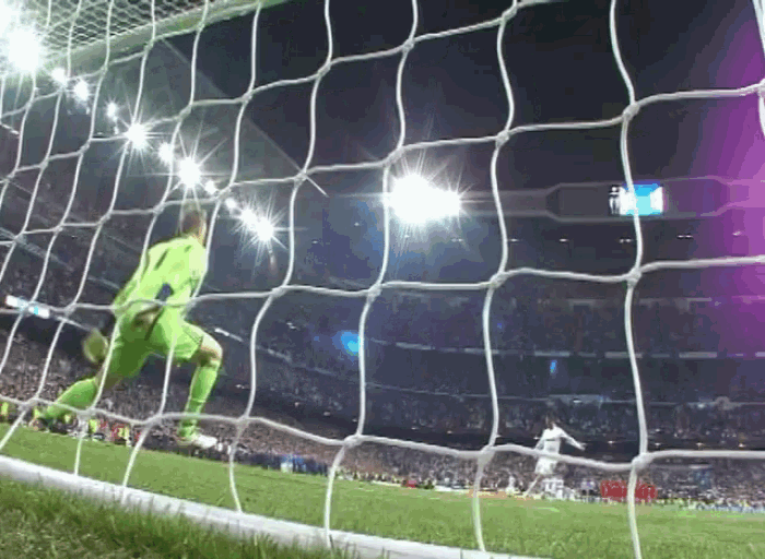 a soccer goalie with the number 1 on his jersey is diving to block a shot