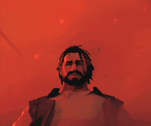 a man with a beard and a bandana around his head looks up at the camera