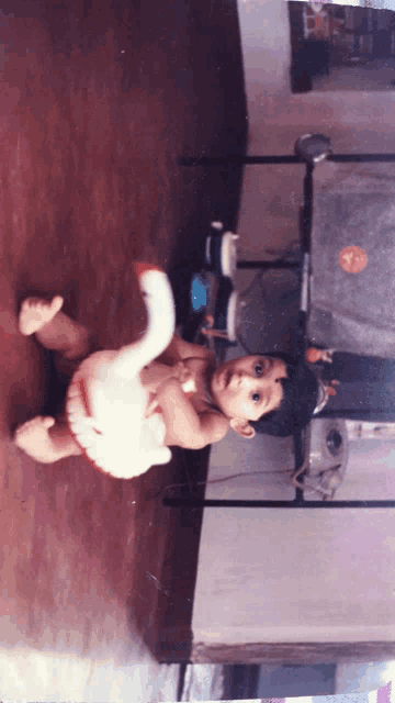 a baby is playing with a stuffed elephant