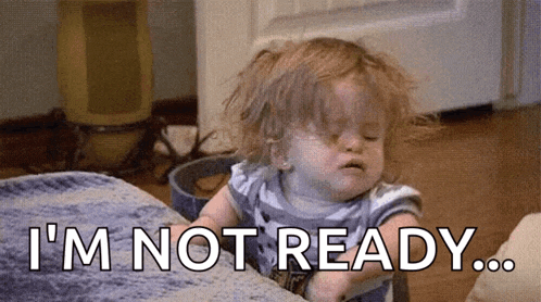 a little girl is sitting on a couch and saying `` i 'm not ready . ''