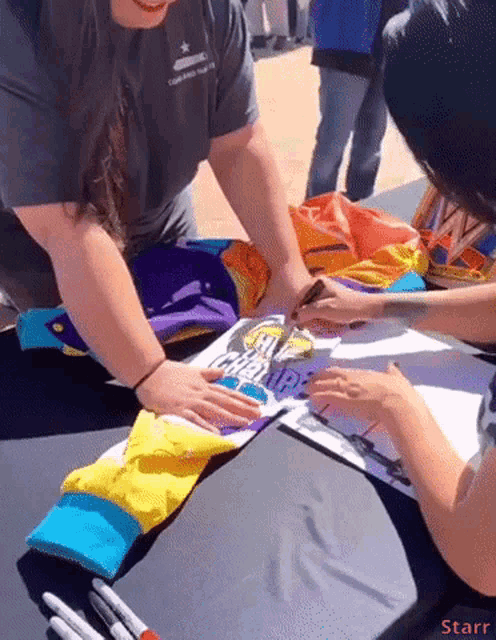 a person signing a piece of paper that says ' help ' on it