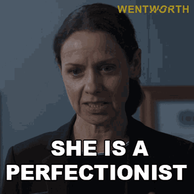 a woman says she is a perfectionist while wearing a black suit