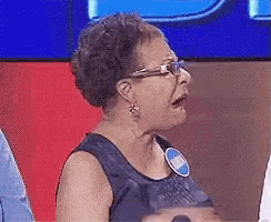 an elderly woman wearing glasses and a name tag that says ' amanda ' on it