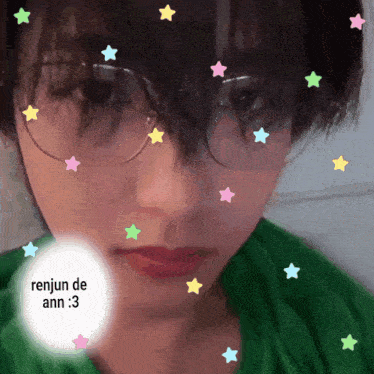 a person wearing glasses and a green shirt with renjun de ann written on it
